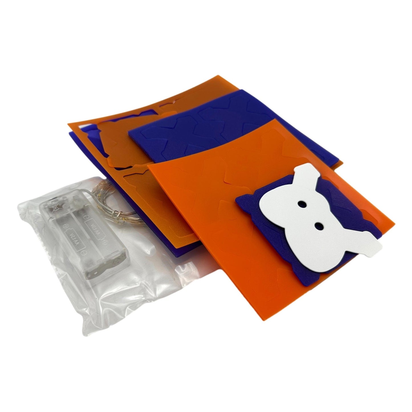 Halloween craft kit with orange and purple foam sheets, a white ghost cutout, and battery-powered string lights.
