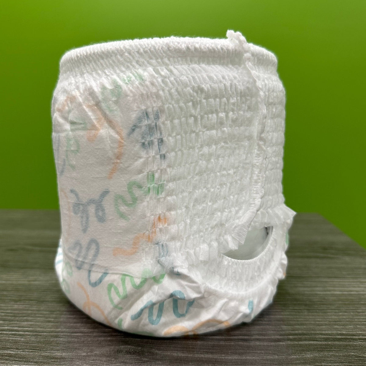 White pull-up diaper with colorful wavy patterns.