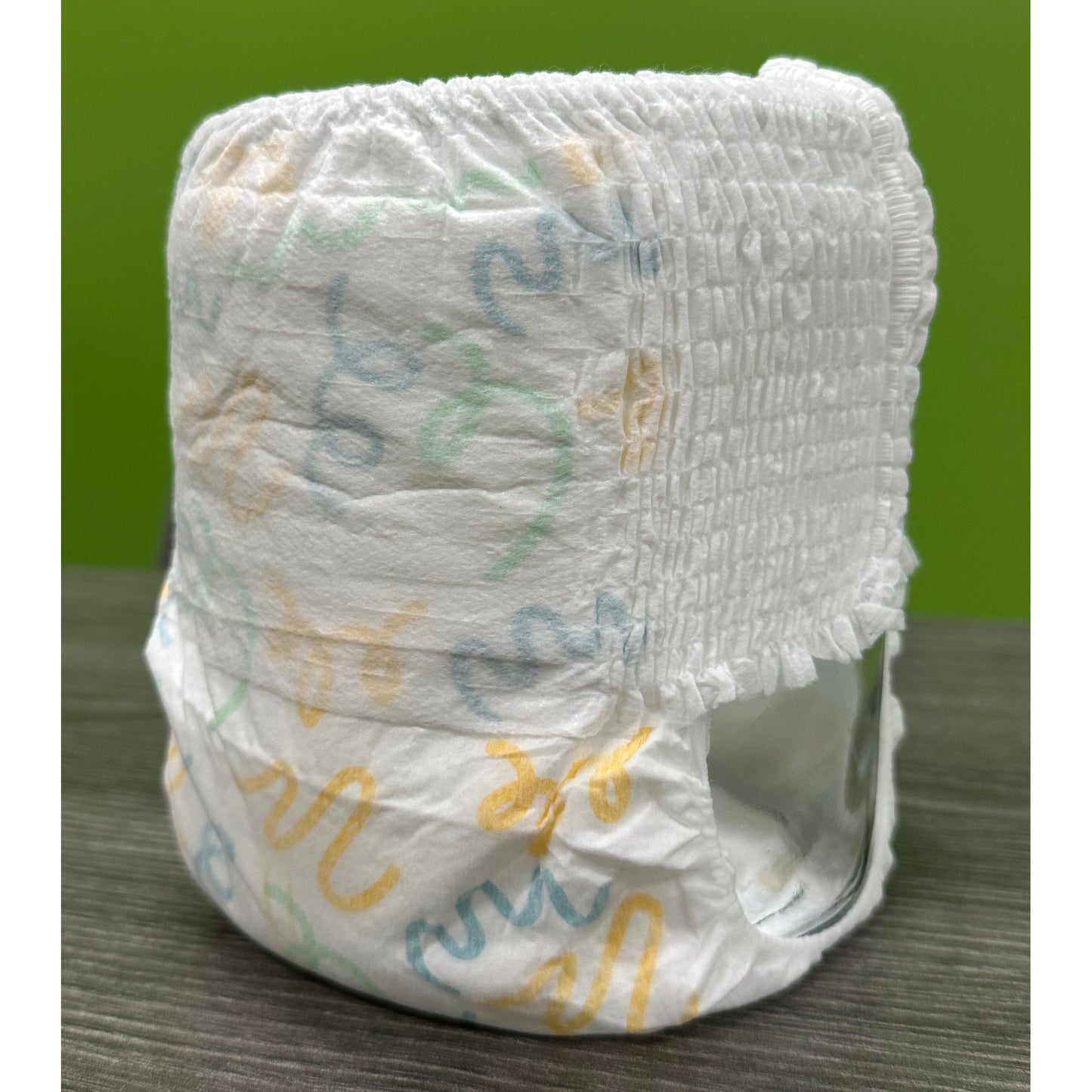 White pull-up diaper with colorful squiggle patterns.