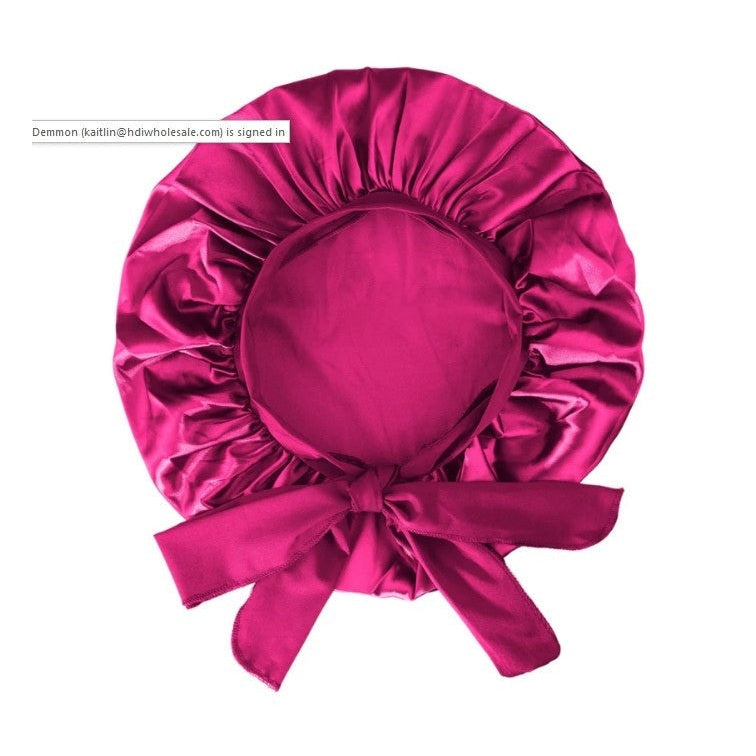 Fuchsia satin hair bonnet with ties.
