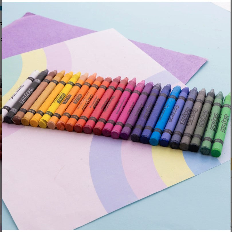 A row of colorful crayons on top of a sheet of paper with pastel-colored rainbow stripes.