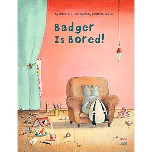 Book cover featuring "Badger is Bored!" A badger is slumped upside down in an armchair, surrounded by scattered objects. The background is a salmon-colored wall and a mint green curtain.