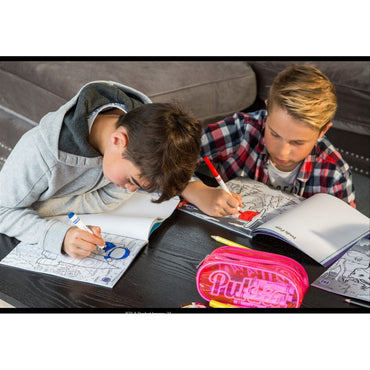 Two boys coloring on doodle pages at a black table, one in a gray hoodie and the other in a red plaid shirt. A pink pencil case sits nearby.