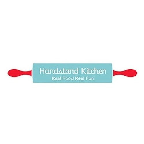 Blue rolling pin with red handles. "Handstand Kitchen, Real Food Real Fun" written on it.