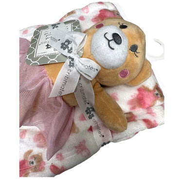 Stuffed animal with pink tutu on patterned blanket.