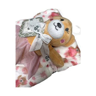Stuffed animal with pink tutu on patterned blanket.