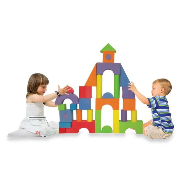 Two children playing with large colorful foam blocks.