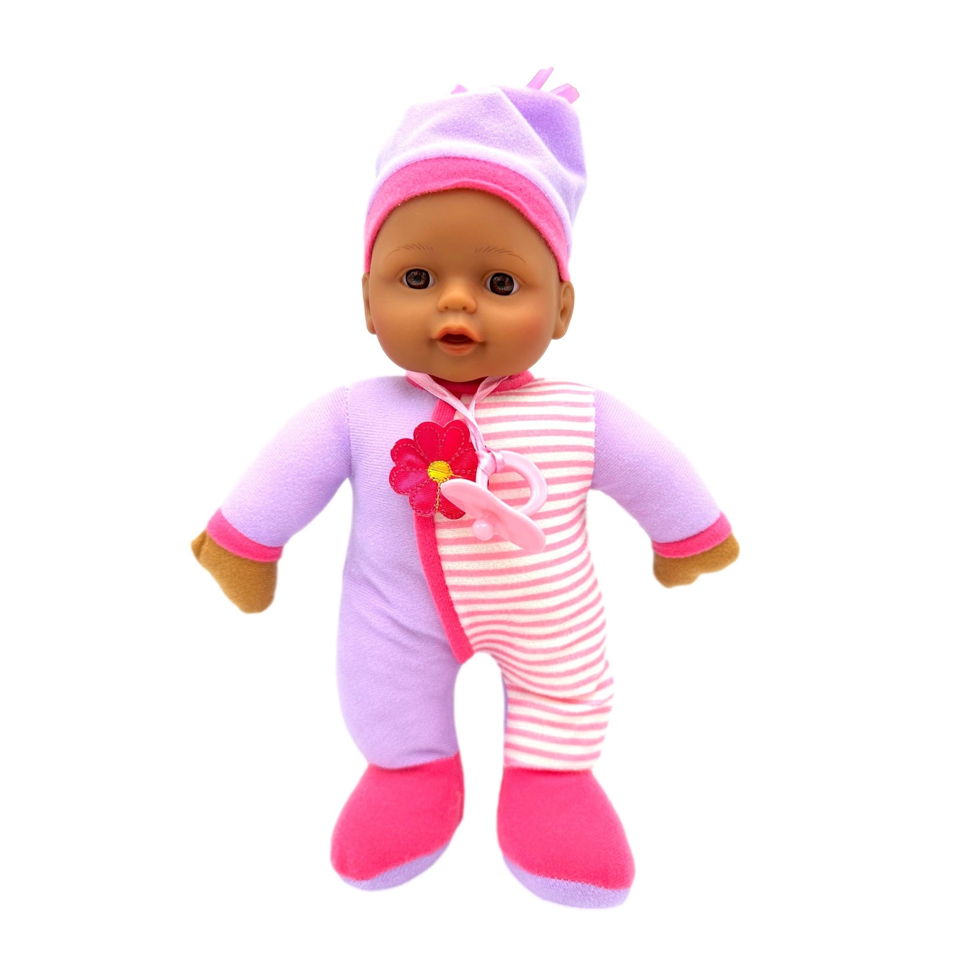 Baby doll with pink and purple pajamas and hat, standing against white.