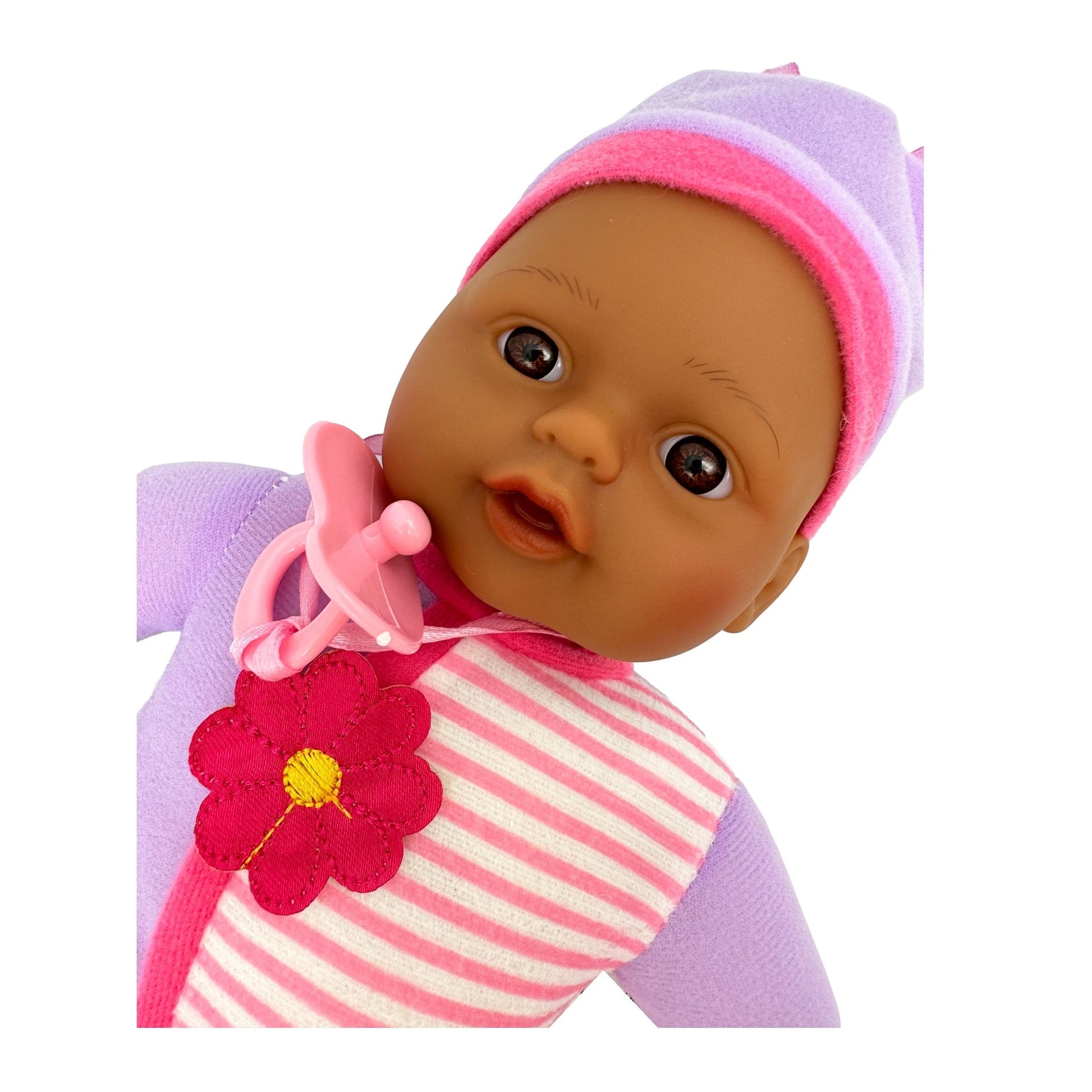 Dark-skinned baby doll wearing a striped shirt, lavender hat, and pink pacifier.