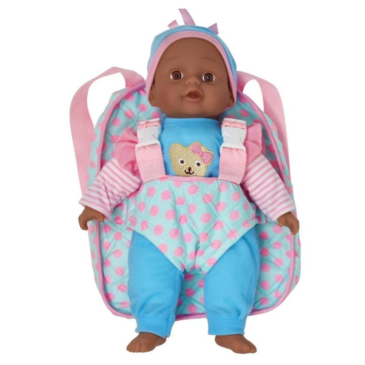 A dark-skinned baby doll wearing blue clothes and a polka-dot carrier backpack.