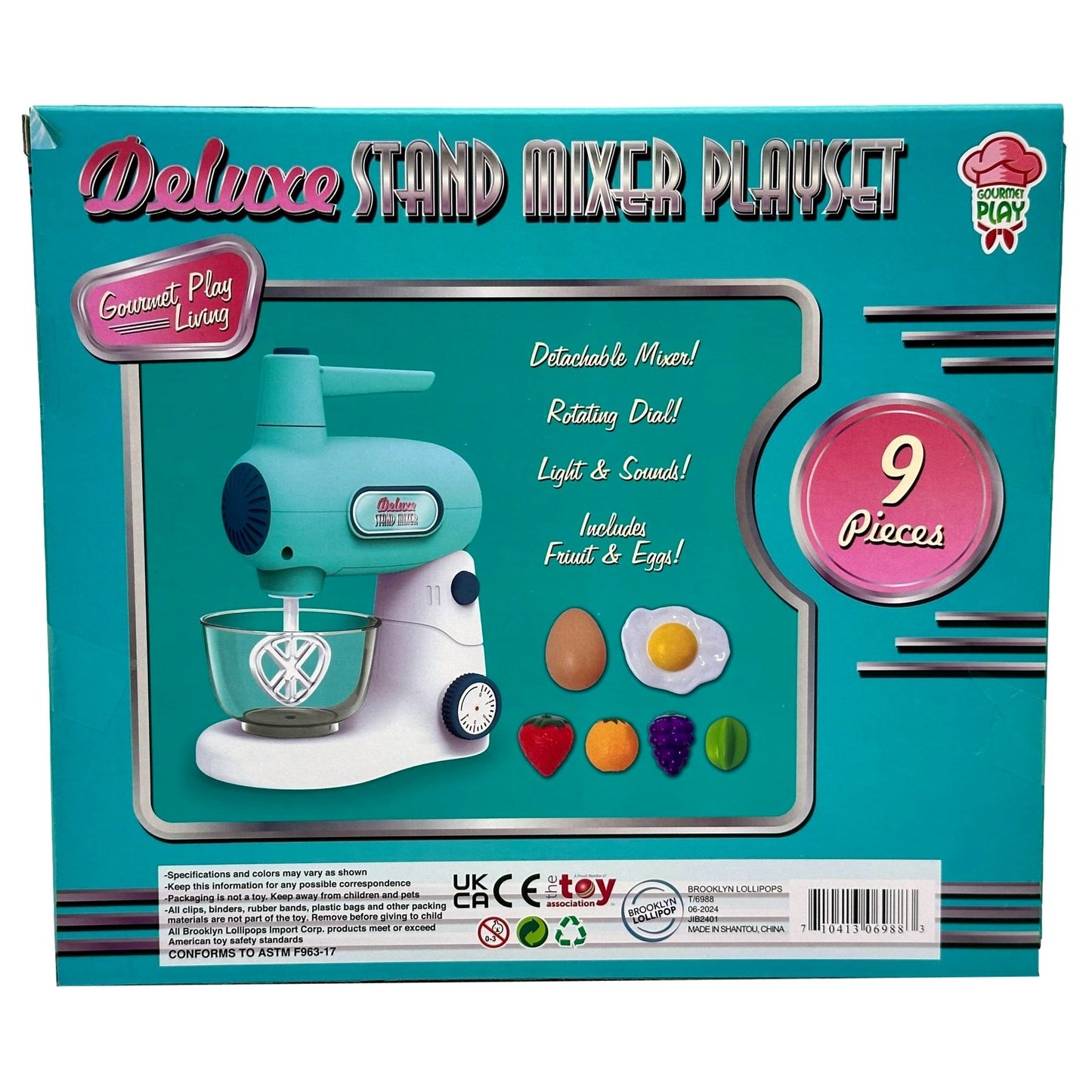 A blue box for a "Deluxe Stand Mixer Playset," with an image of a toy stand mixer and various fruits and eggs.