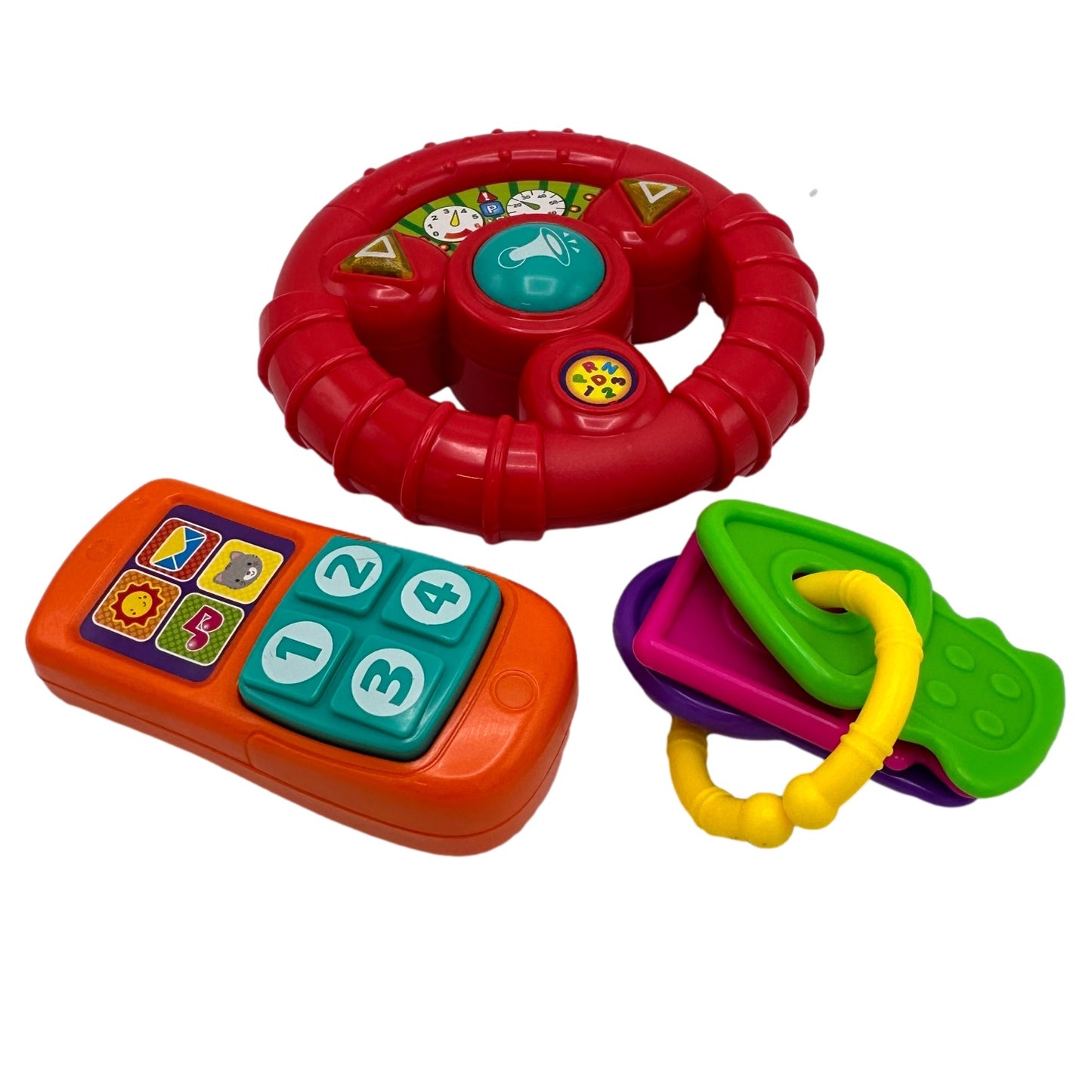 A red toy steering wheel, an orange toy phone with buttons, and a set of multicolored plastic keys.