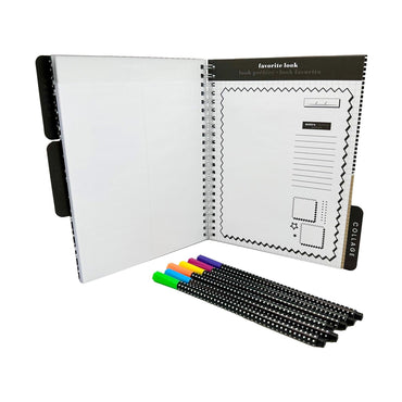 An open spiral notebook with black and white patterned pages, labeled "favorite look" and "collage", with a set of colorful markers.