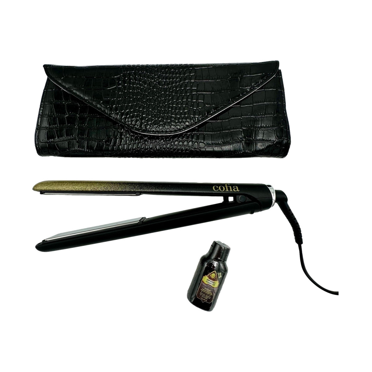 A black clutch with a reptile skin pattern sits above a black and gold flat iron and a bottle of hair oil.