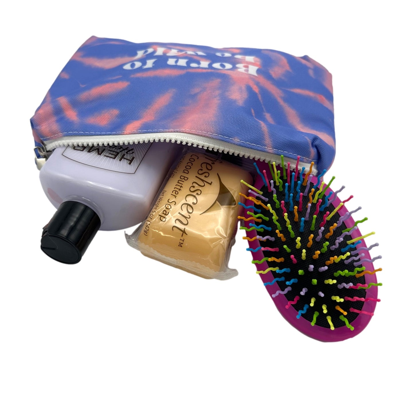 Tie-dye cosmetic bag partially open with skincare products and a hairbrush inside.