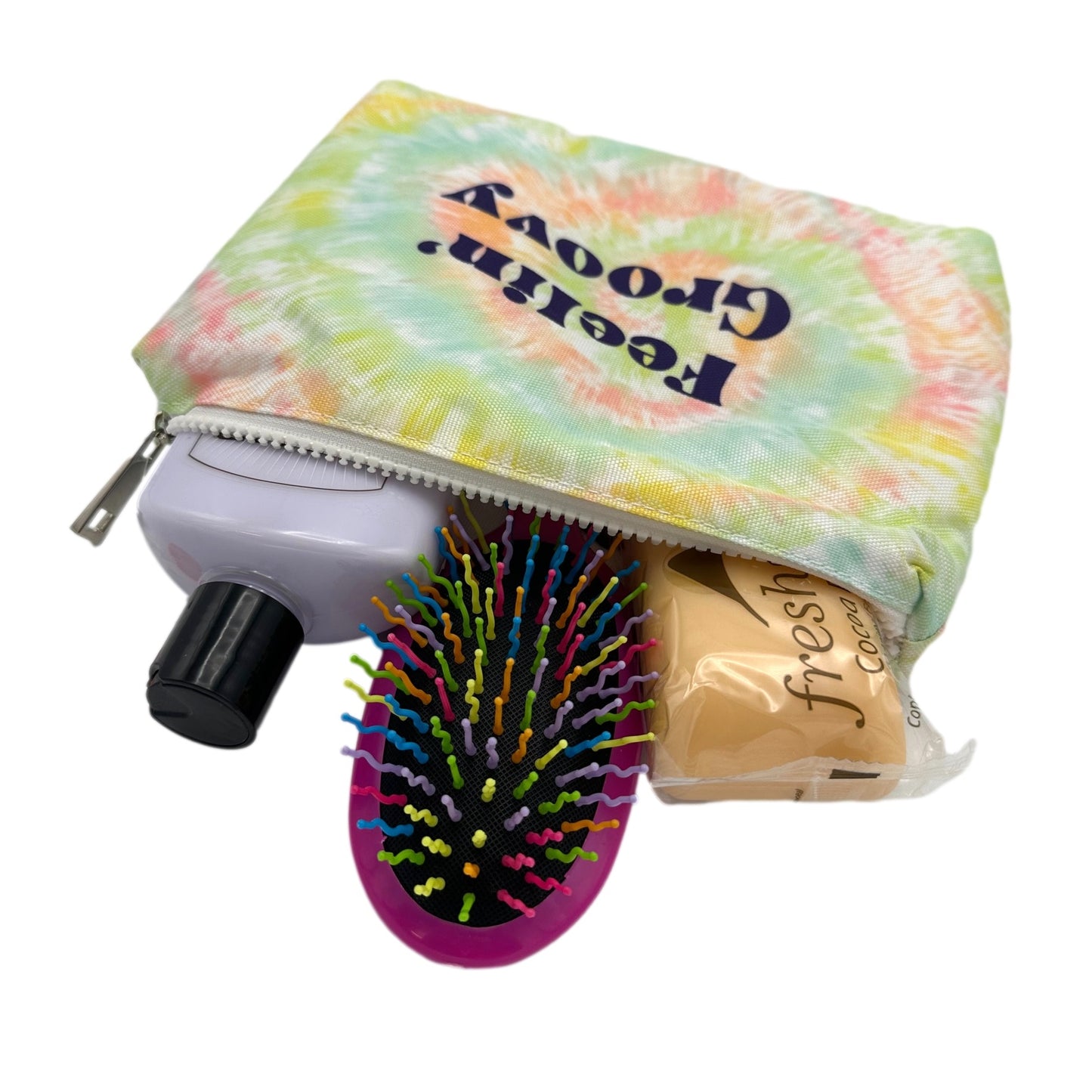 Open tie-dye cosmetic bag with toiletries inside.