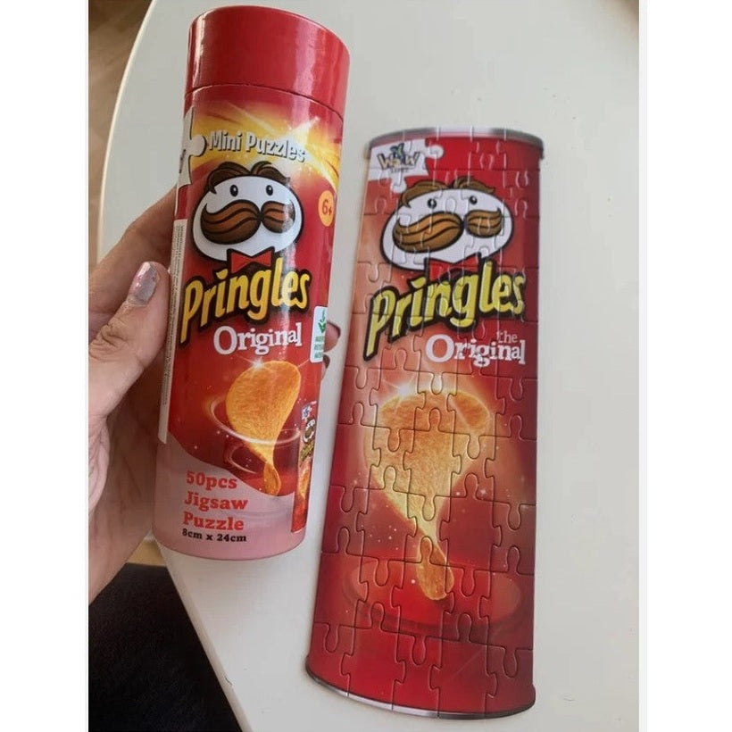 Two Pringles Original jigsaw puzzles, one in its cylindrical container.