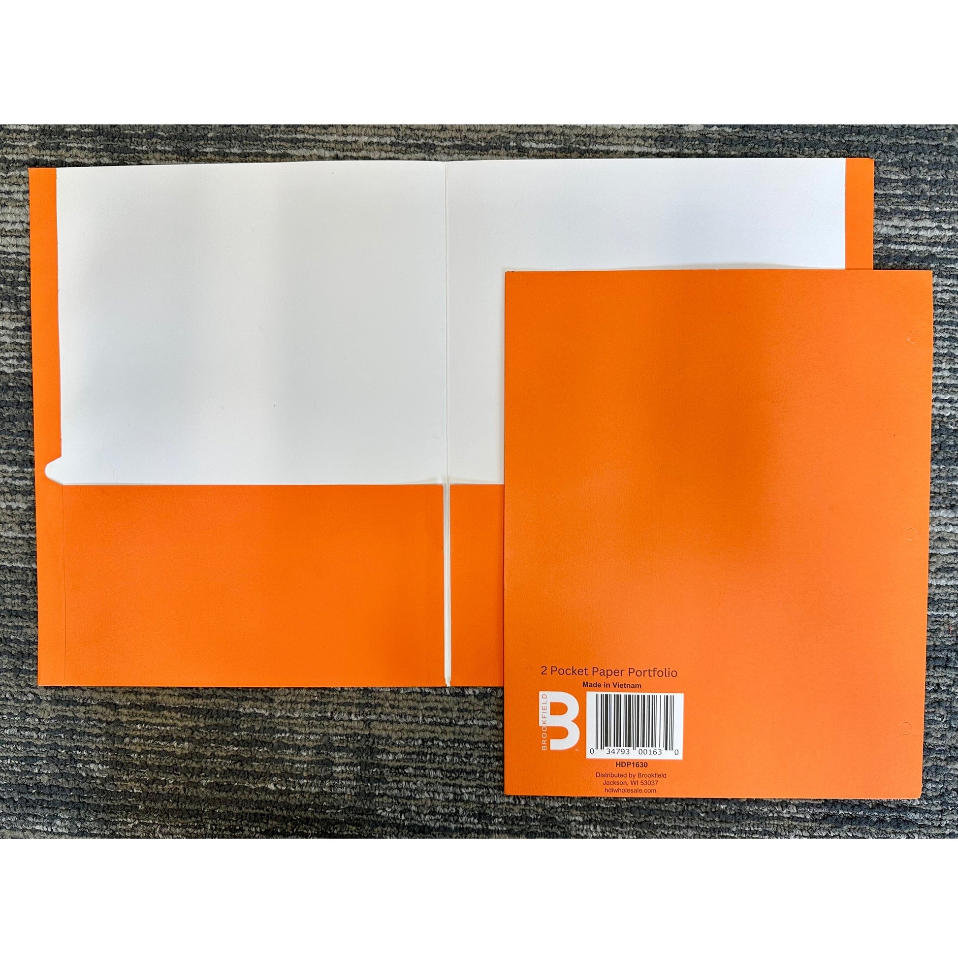 Open, orange two-pocket paper portfolio on gray carpet.