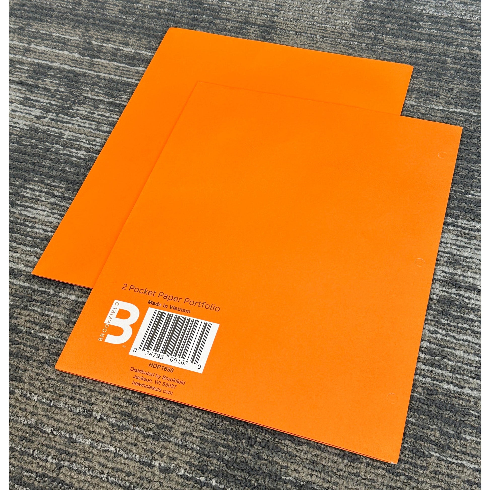 Two orange Brookfield 2-pocket paper portfolios on a gray carpet.