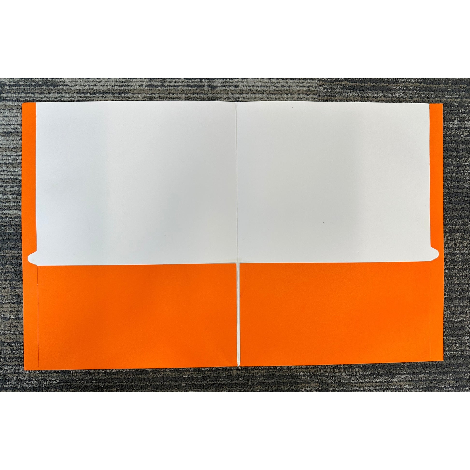 Open, two-pocket orange and white folder on gray carpet.