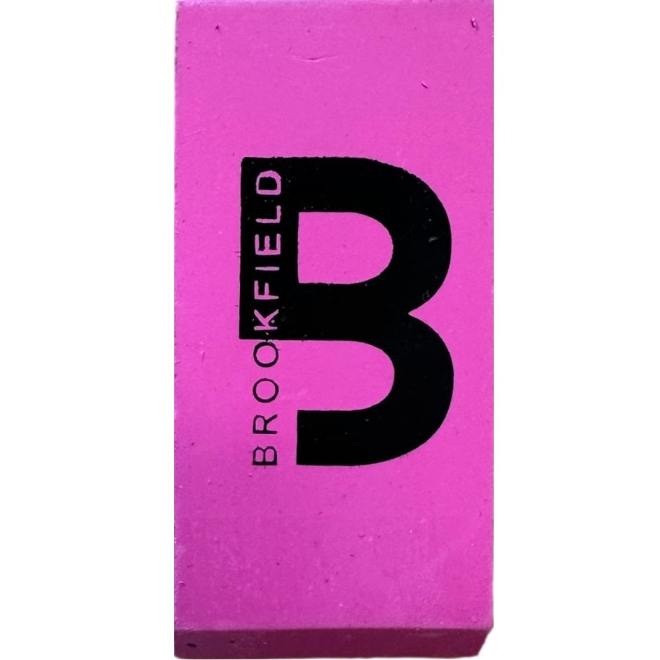 A pink eraser with the word "Brookfield" and a letter "B" printed in black.