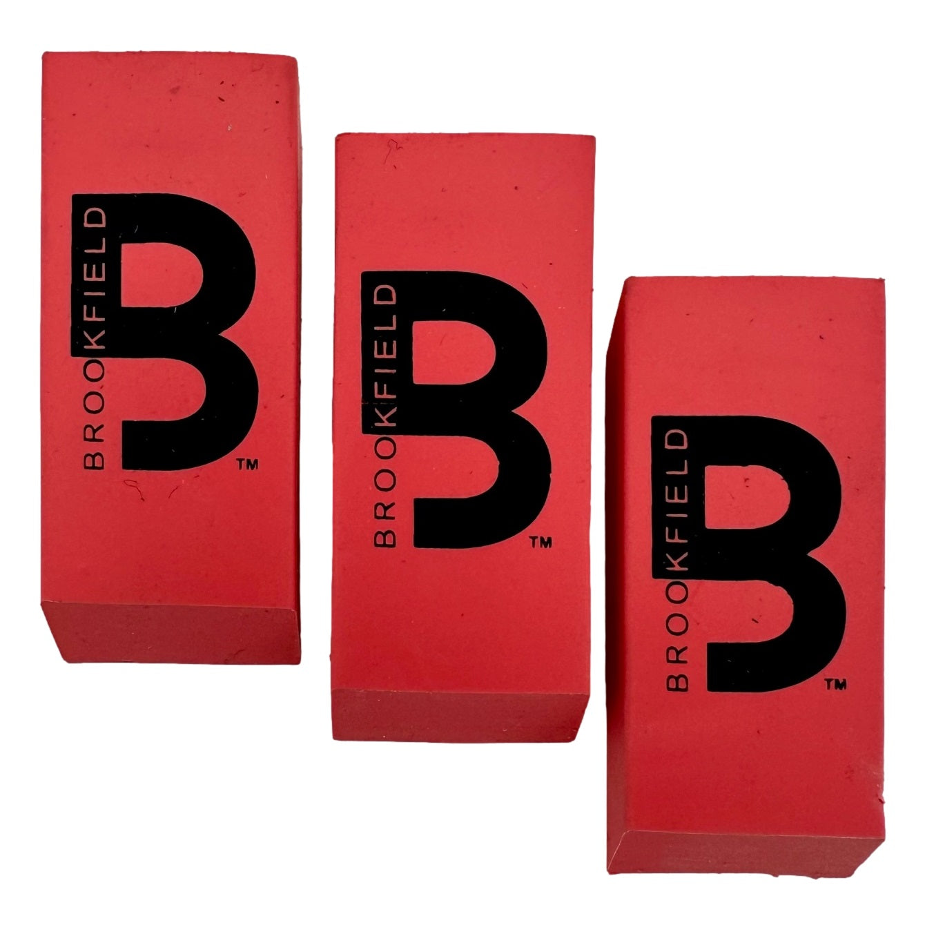 Three red erasers with black "Brookfield" logo.