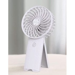 Here are some descriptive alt tags for the image:
* White portable handheld fan with stand.
* Small personal fan on a white surface.
* Compact white electric fan with folding handle.
* Close-up of a handheld fan, white color.