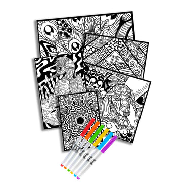 A stack of black and white coloring pages with a set of colored markers in front of them.