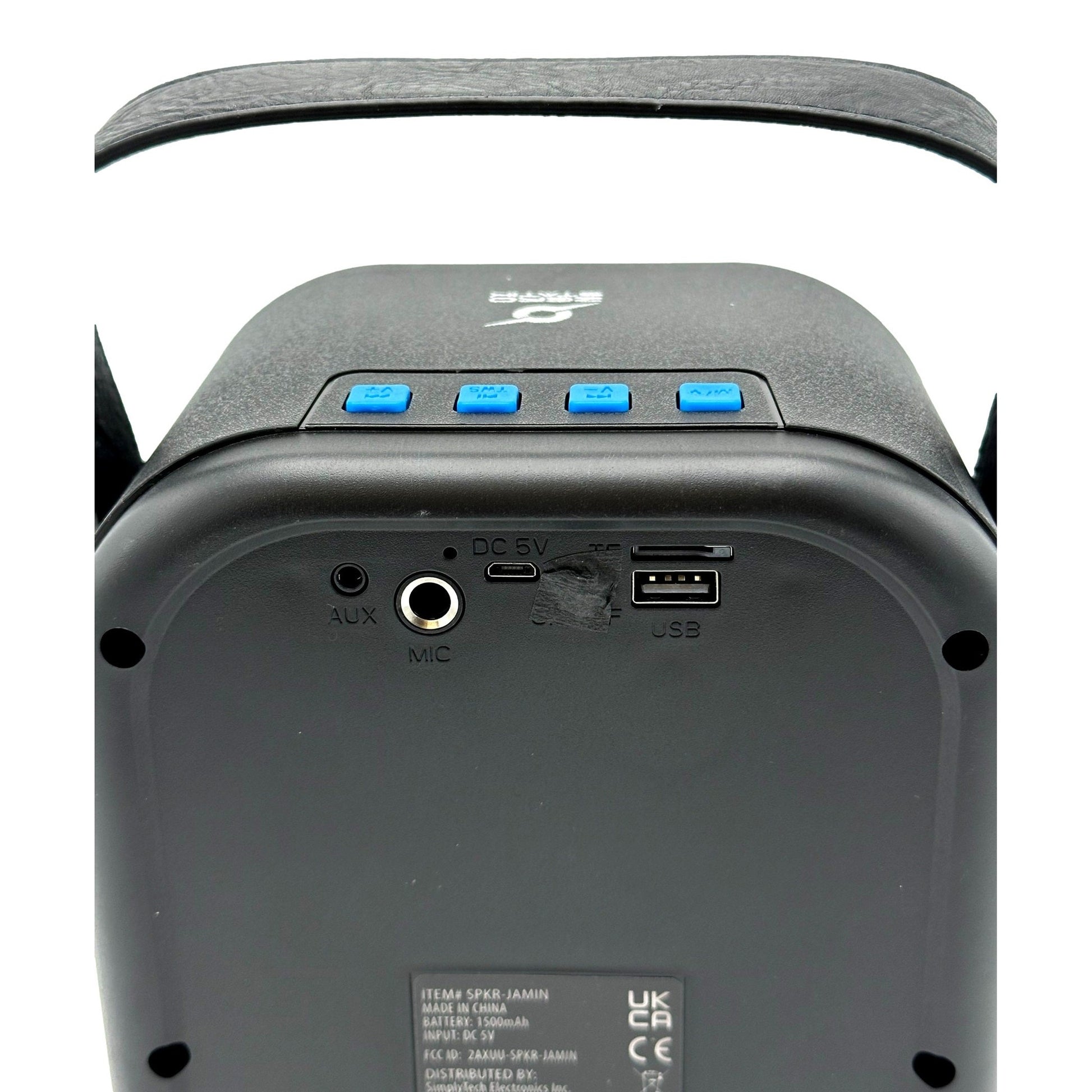 Close-up of a black portable speaker with blue buttons, various ports, and a handle.