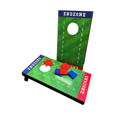 Two cornhole game boards with an American football field design and red and blue bean bags.