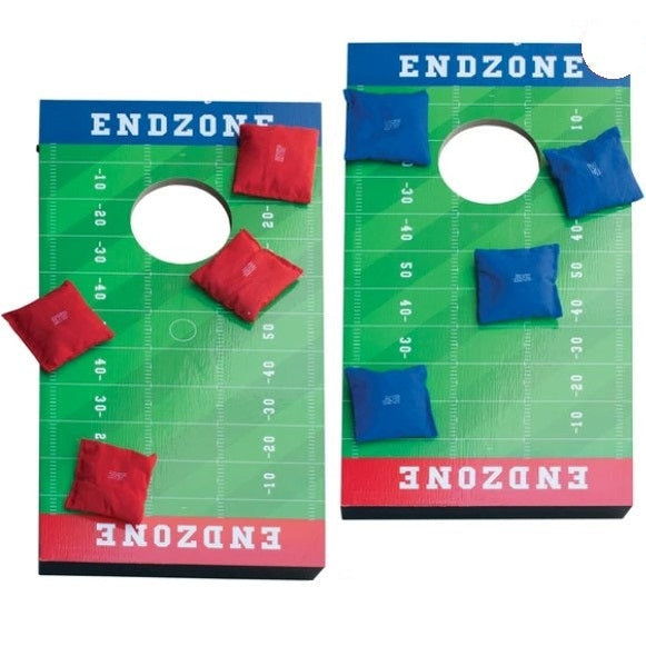 Two cornhole boards with a football field pattern and beanbags.