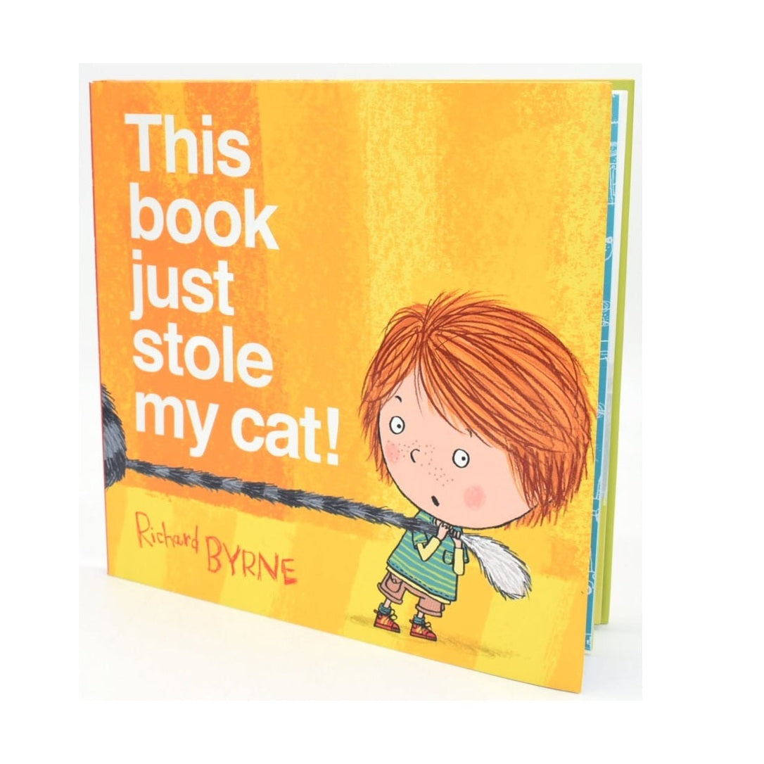 Children's book, "This Book Just Stole My Cat!", featuring a cartoon boy holding a cat's tail.