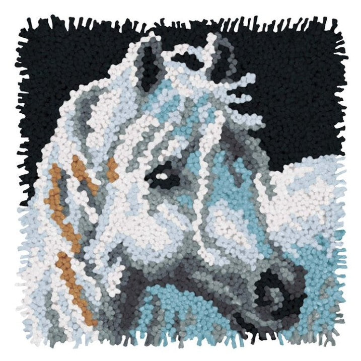 Close-up of a tufted, square horse-themed rug.