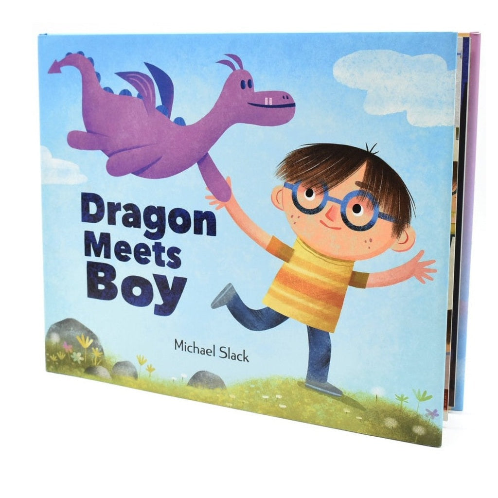 Front cover of children's book, "Dragon Meets Boy" by Michael Slack, features a purple dragon flying with a boy with glasses and a yellow and orange striped shirt against a blue sky with clouds and grass.