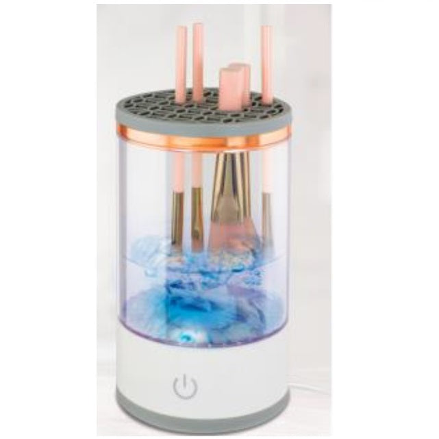 Cylindrical makeup brush cleaner with water and brushes inside.