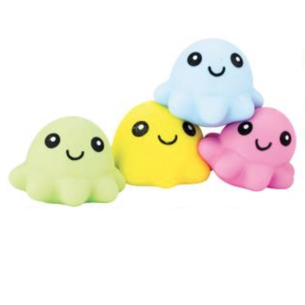 Four colorful ghost-shaped toys on a white background