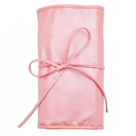 Pink faux leather makeup brush roll with bow tie.