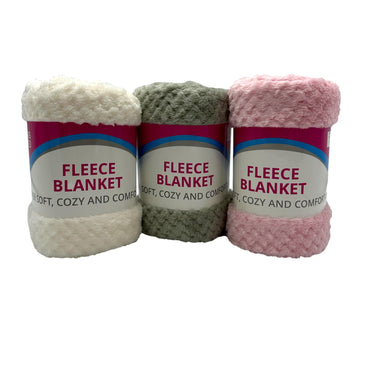 Three rolls of fleece blankets in white, gray, and pink.
