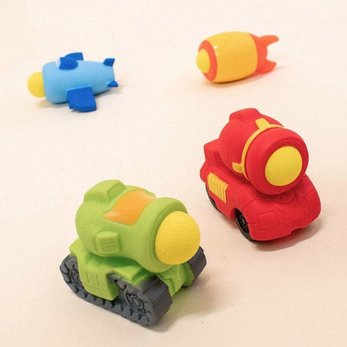 Four colorful toy erasers shaped like a plane, rocket, and tanks.
