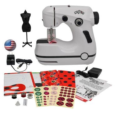 A white and black sewing machine with accessories, including fabric, stickers, and patterns.