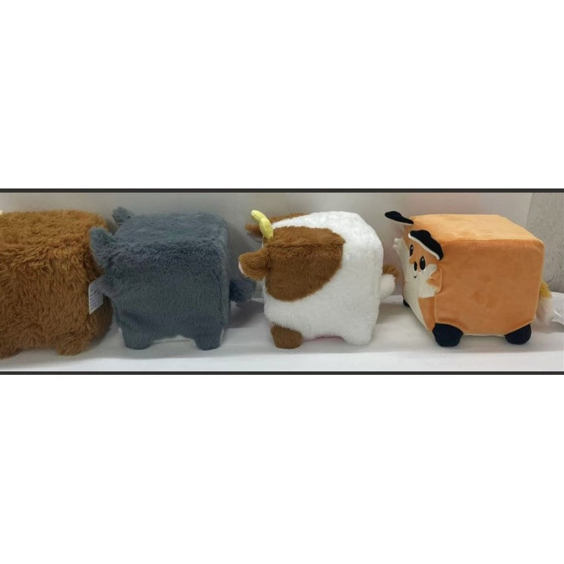 Four cube-shaped stuffed animals of brown bear, gray elephant, brown and white cow, and orange fox, facing away.