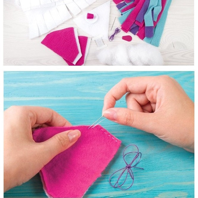 A person sewing bright pink fabric on a blue wooden surface with other crafting materials visible above.