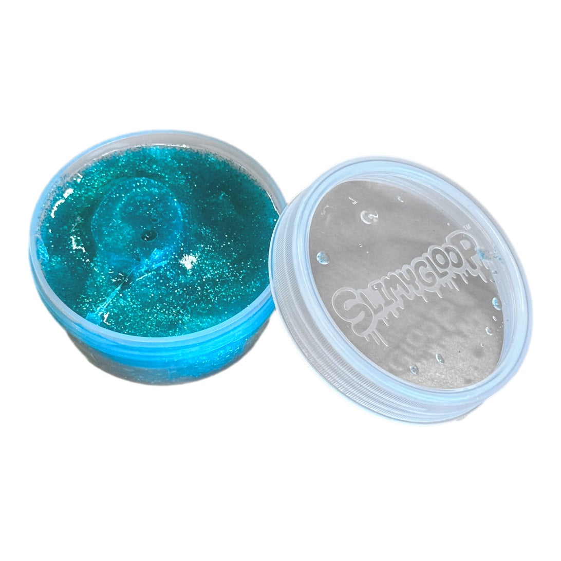 Open container of blue glitter slime with the lid beside it.