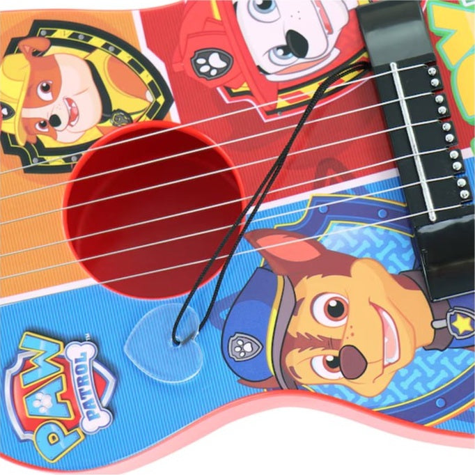 Close-up of a Paw Patrol guitar toy, showcasing the characters Rubble, Marshall, and Chase on a blue background.