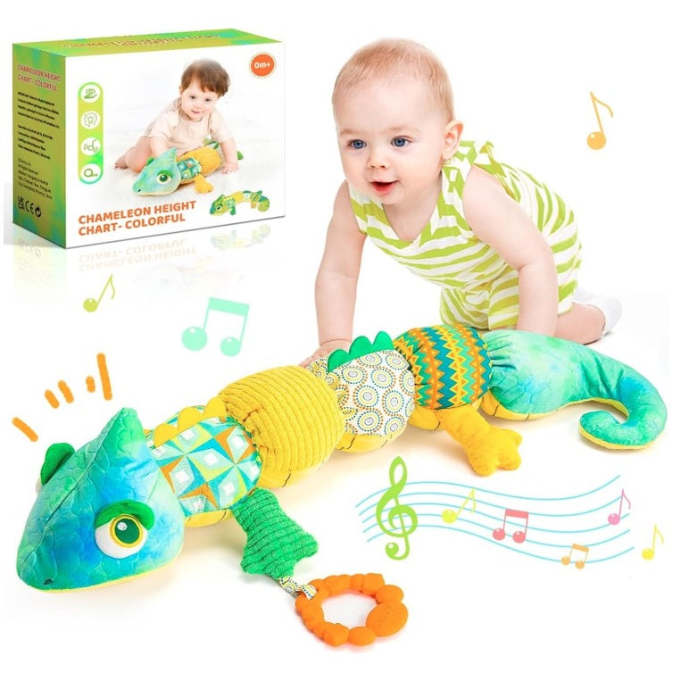 A baby in a green and white striped shirt crawls next to a long, colorful chameleon plush toy. A box shows a photo of a baby with the toy. Musical notes appear around the baby and toy.