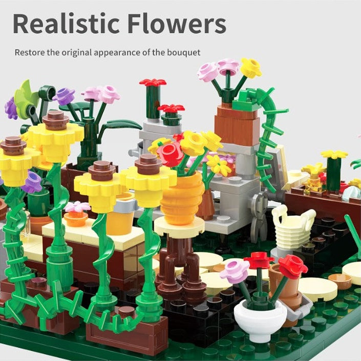 Lego-built flowers in various colors and vases, arranged on a dark green base. Above the display, the phrase "Realistic Flowers" is visible.
