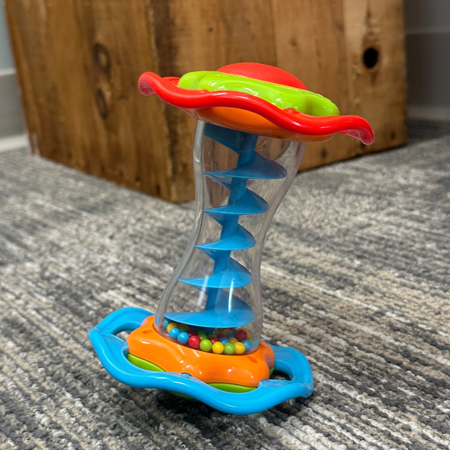 Colorful baby toy with beads in a clear tube.