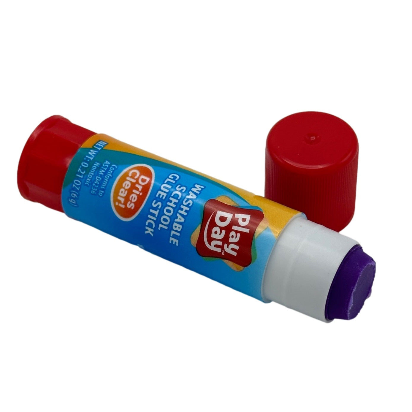 Open tube of purple Play Day brand glue stick with separate red cap.