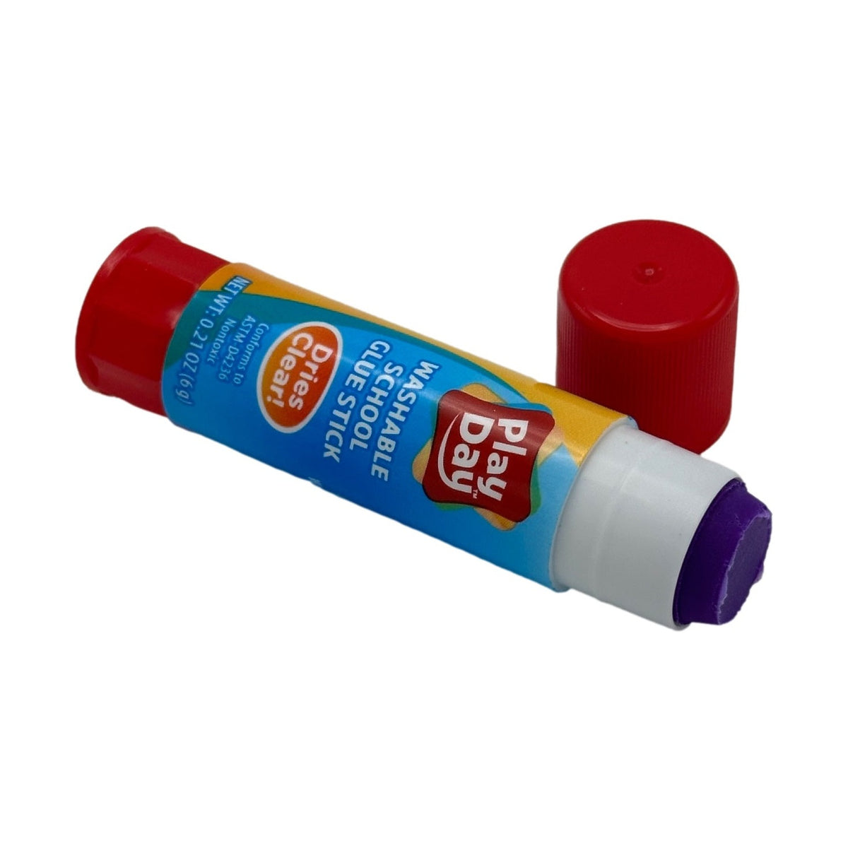 Open tube of purple Play Day brand glue stick with separate red cap.