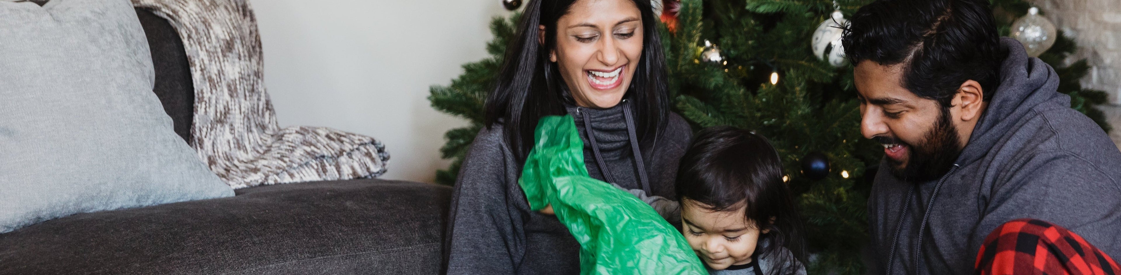 Happy family unwrapping holiday presents